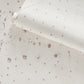A white polka dot pattern on the Bandanarama Wallpaper Birch surface