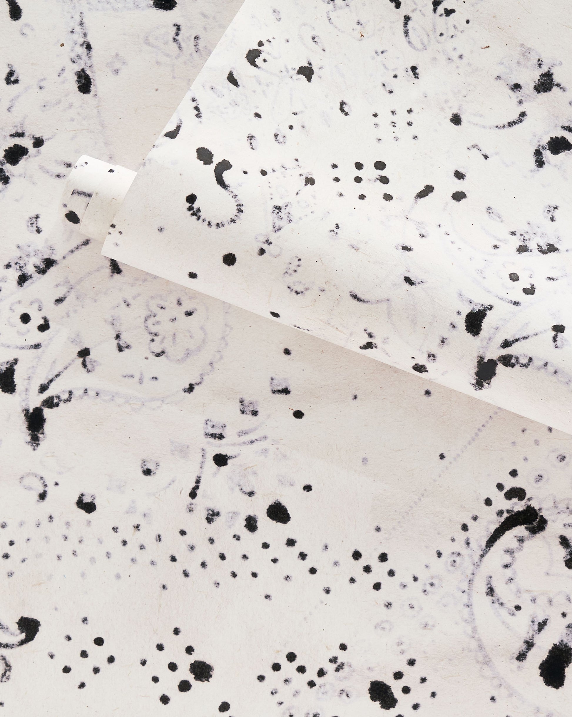 A white and black splatter pattern on a piece of Bandanarama Wallpaper Ink