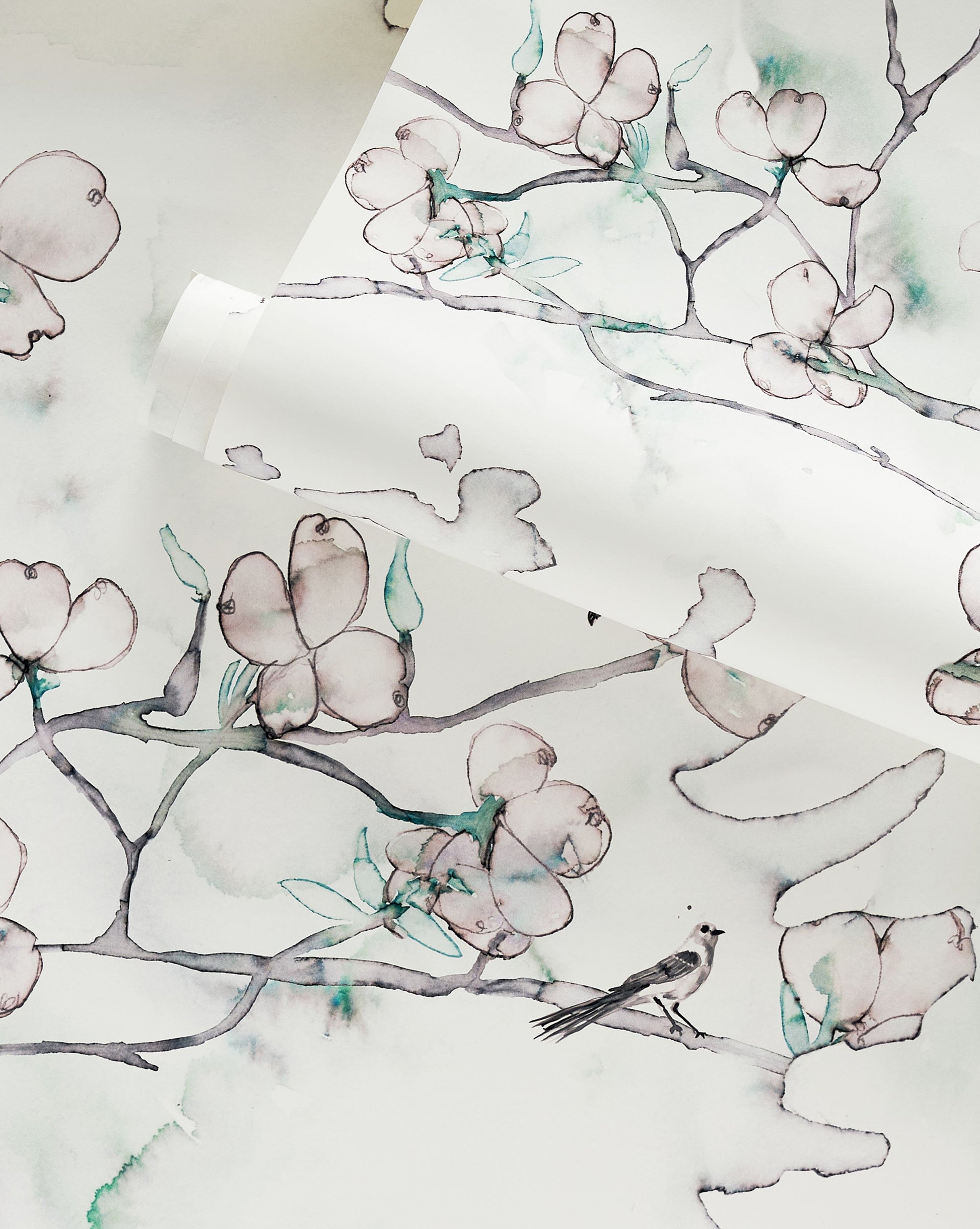 A custom luxury Dogwood Dreams Wallpaper in a botanical motif with a Spruce colorway and a bird and flowers is depicted on it