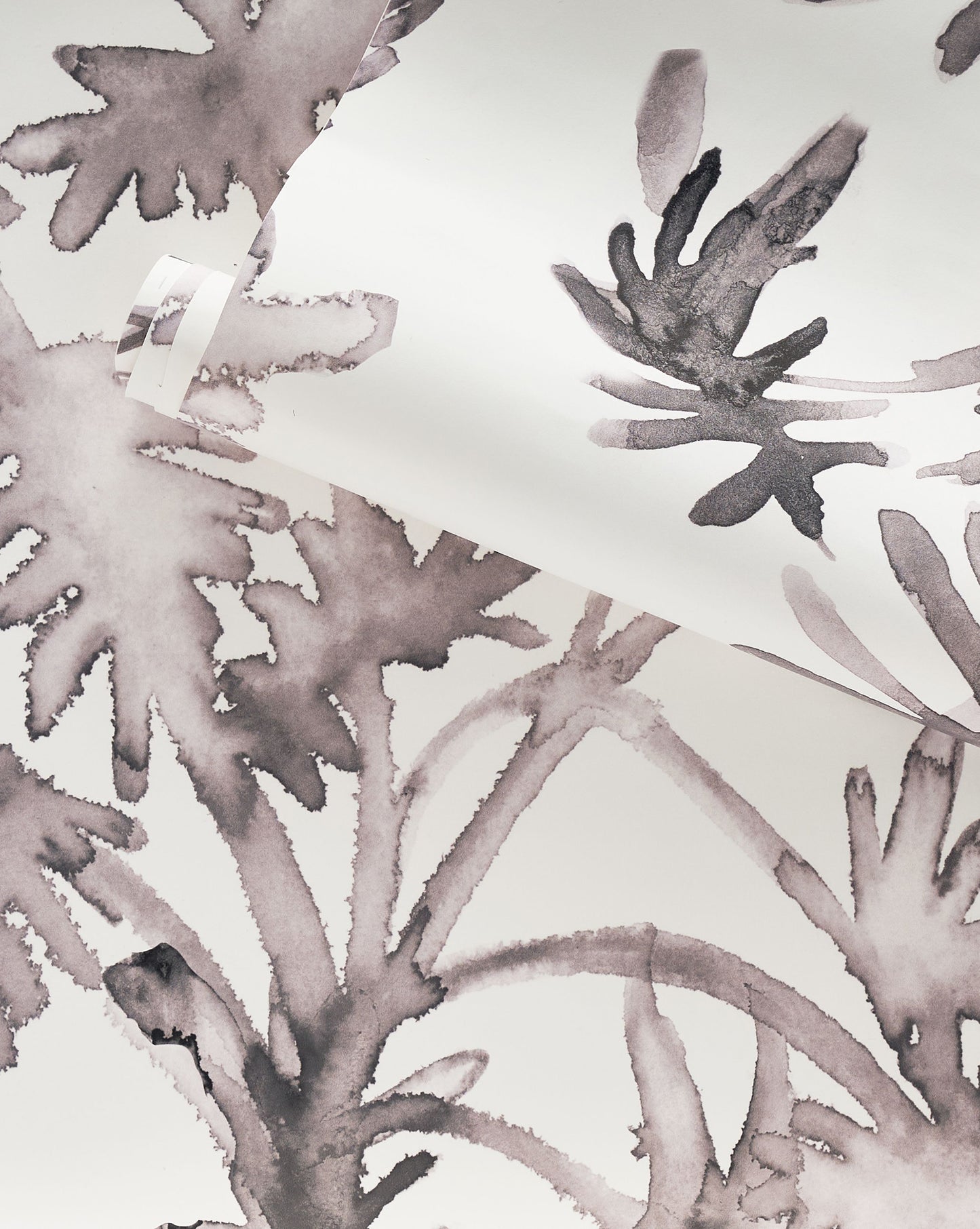 A luxury custom Topiary Wallpaper with a botanical design of grey and white leaves on it