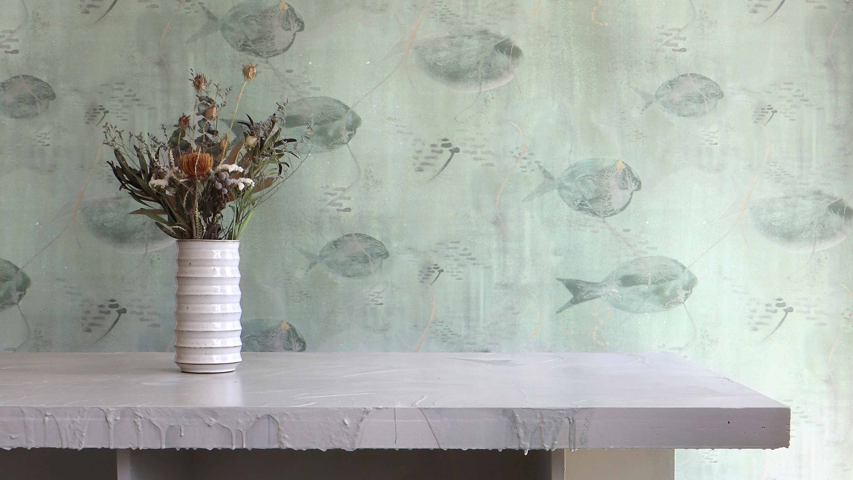 Shoal Aqua wallpaper has a warm green hue with school of fish. 