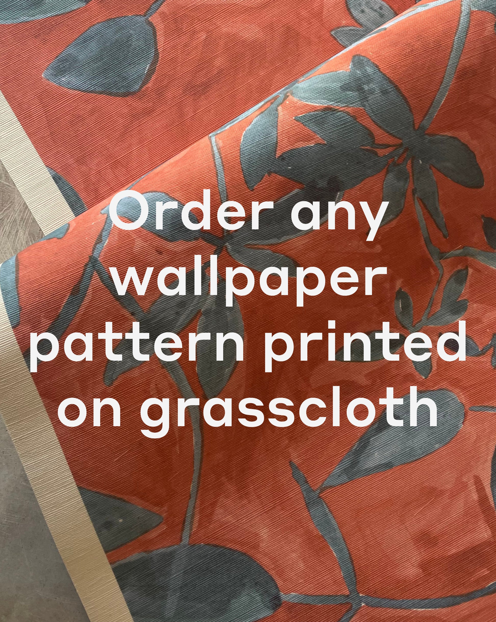 A close-up of Custom Grasscloth wallpaper in red with a blue floral pattern and white text stating, "Order any wallpaper pattern printed on grasscloth.