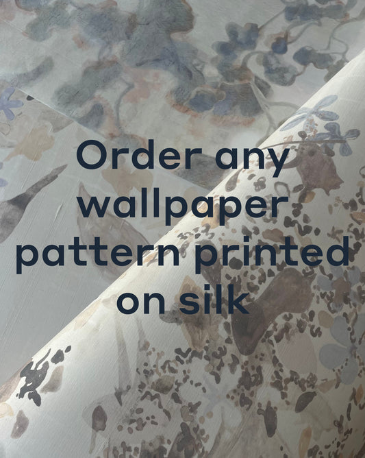 Close-up of silk fabric with floral wallpaper patterns, overlaid with text: "Order any Custom Silk Wallcovering or your own designs printed on our exclusive silk selection.