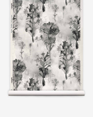 Aionas Grasscloth in Phyllite, featuring a grayscale watercolor pattern of stylized trees and flowers on textured sisal.