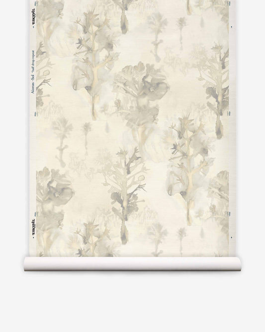Aionas Grasscloth||Sol wallpaper featuring a watercolor botanical pattern of muted gray and tan trees on textured off-white hand woven sisal grasscloth.