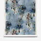 Aionas Grasscloth wallpaper roll in Thalassa featuring a blue watercolor pattern of stylized trees and abstract foliage.