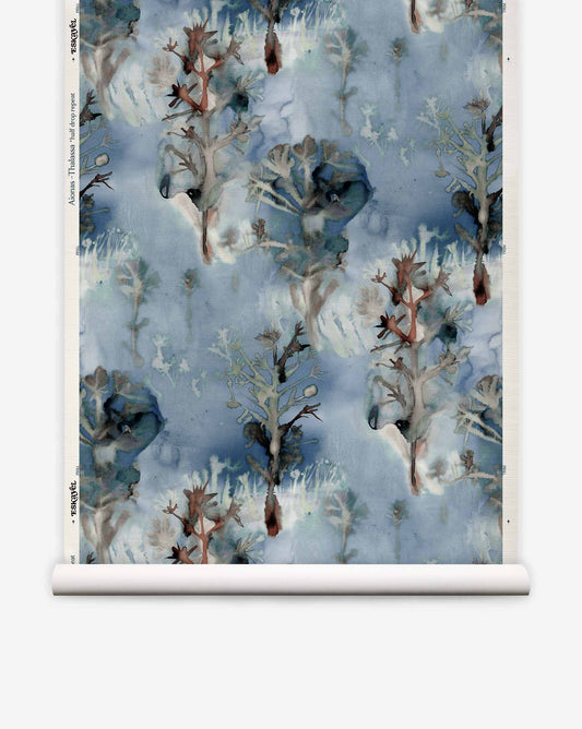 Aionas Grasscloth wallpaper roll in Thalassa featuring a blue watercolor pattern of stylized trees and abstract foliage.