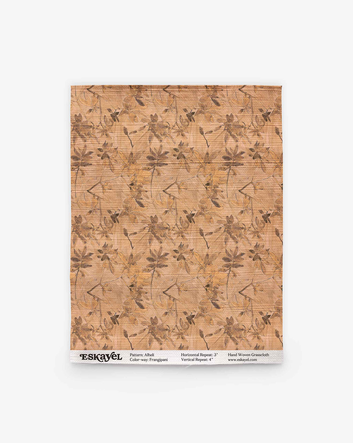 Alhelí Grasscloth||Frangipani brown-toned botanical wallpaper featuring frangipani flowers and leaves over a textured background, with printed product information at the bottom.