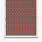 A roll of Alhelí Grasscloth in Lobelia, featuring a repeating pattern of blue floral sprays and dark thin stems on a textured, rust-orange background.
