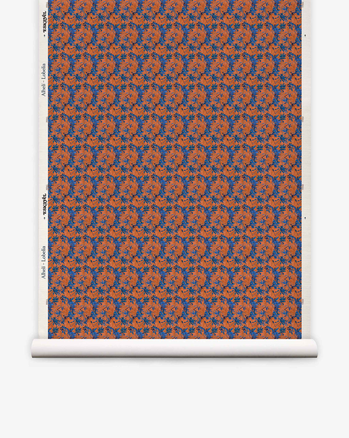 A roll of Alhelí Grasscloth in Lobelia, featuring a repeating pattern of blue floral sprays and dark thin stems on a textured, rust-orange background.