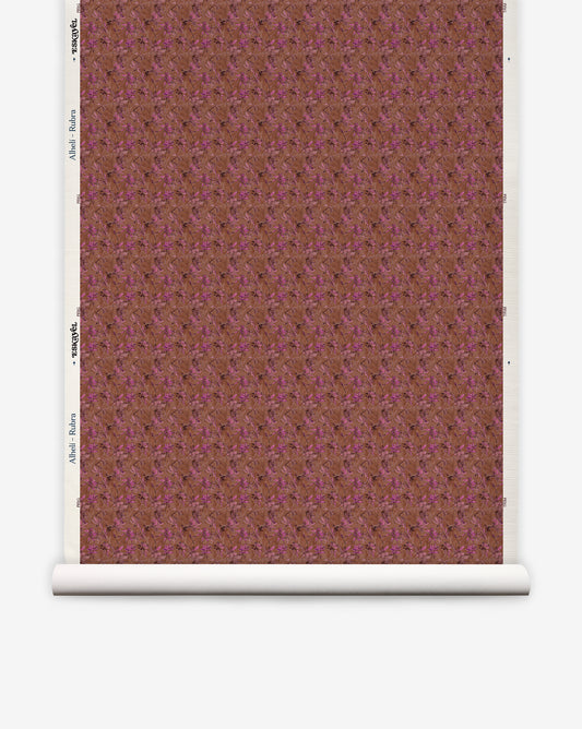 A roll of Alhelí Grasscloth||Rubra eco-friendly wallpaper featuring a deep brown and magenta floral pattern on a textured background.