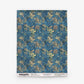 A rectangular Alhelí Grasscloth Sample in Tide Pool, featuring a blue grasscloth texture with a pattern of tan and green floral sprigs.
