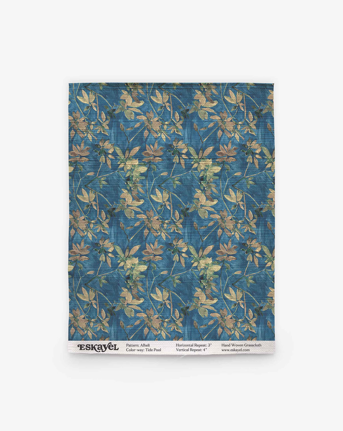 A rectangular Alhelí Grasscloth Sample in Tide Pool, featuring a blue grasscloth texture with a pattern of tan and green floral sprigs.