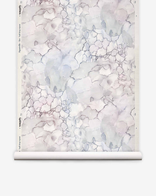 A roll of eco-friendly Aquarelle Grasscloth||Ice wallpaper featuring an abstract, crackled pattern of light blue and grey shapes.
