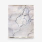 A rectangular Aquarelle Grasscloth Sample in Ice, featuring a white, horizontal grasscloth texture with a watercolor-style blue and black marble pattern.