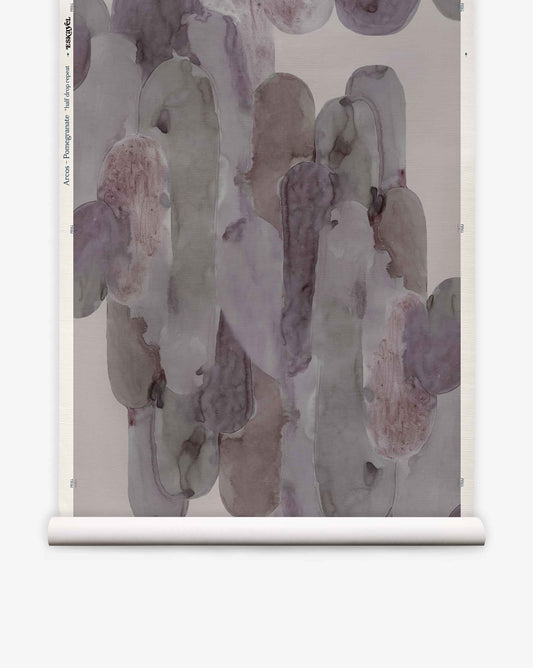 Bring an artful serenity into any space with the Arcos Grasscloth||Pomegranate wallpaper. Featuring overlapping brushstrokes in muted gray, lavender, and taupe tones, this nature-inspired design evokes the subtle textures of hand-painted wallpaper. Displayed on a roll against a white background, it offers the refined look of grasscloth wallpaper with a modern abstract twist.