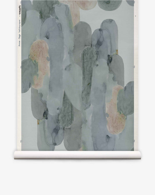 Arcos Grasscloth||Sage wallpaper roll showcases a watercolor-style, hand-painted design with abstract, overlapping shapes in muted green, blue, and beige tones. Displayed upright against a plain background, it offers a nature-inspired look for your space.
