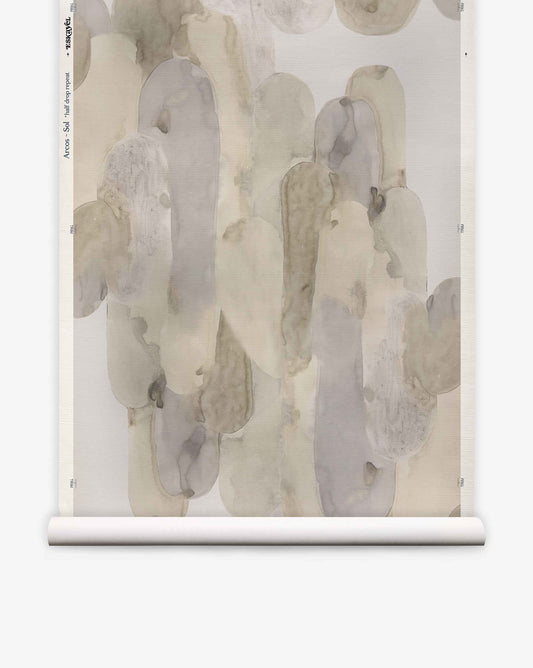 Arcos Grasscloth||Sol is a rolled-up wallpaper featuring an abstract, nature-inspired watercolor pattern in muted gray, beige, and taupe tones set against a crisp white background.