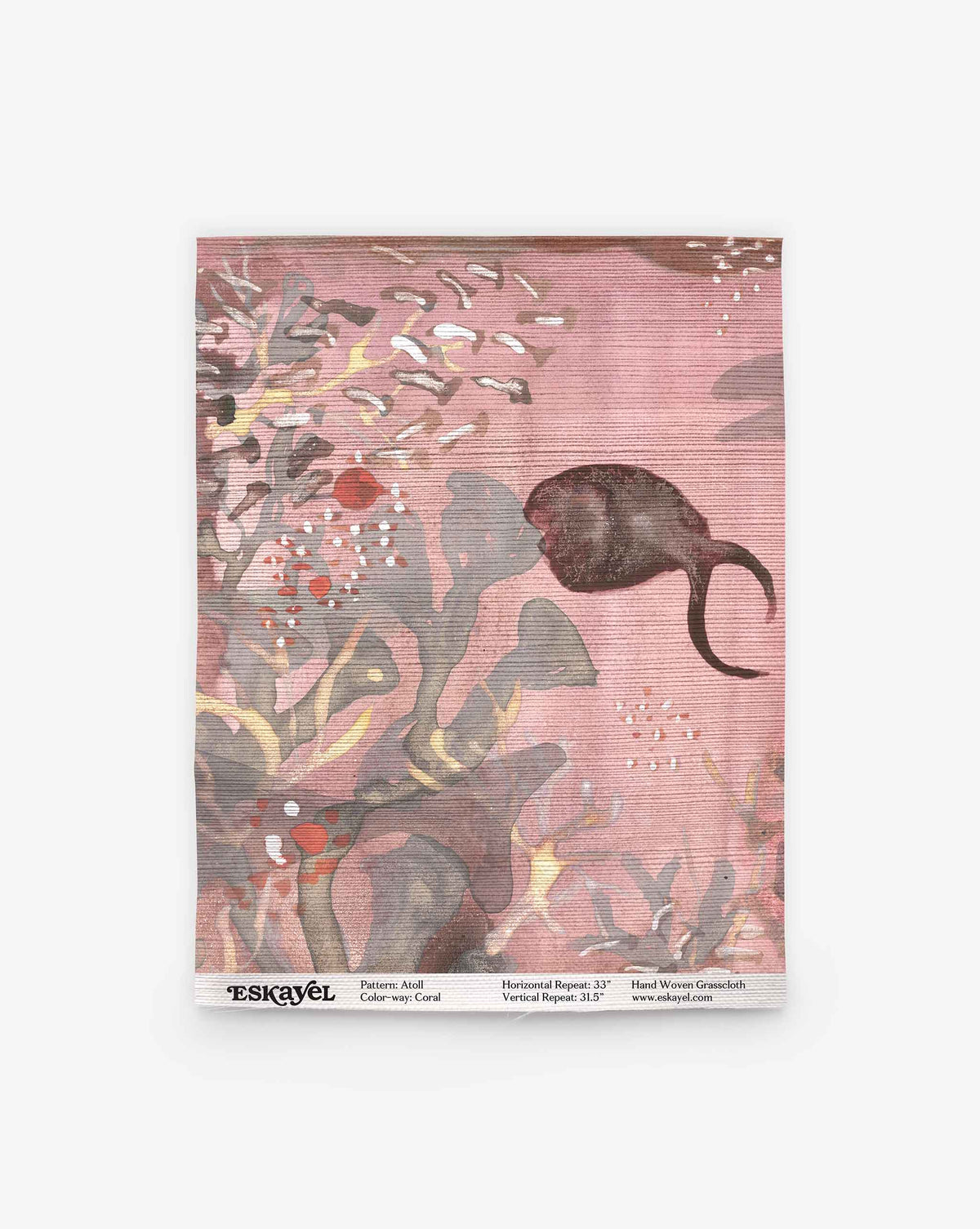 A coral pink-toned Atoll Grasscloth Sample features abstract botanical shapes and a dark fish swimming to the right, with the product label visible at the bottom. Order a sample to experience this unique design firsthand.