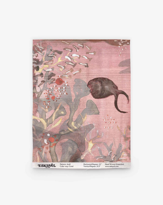 A coral pink-toned Atoll Grasscloth Sample features abstract botanical shapes and a dark fish swimming to the right, with the product label visible at the bottom. Order a sample to experience this unique design firsthand.