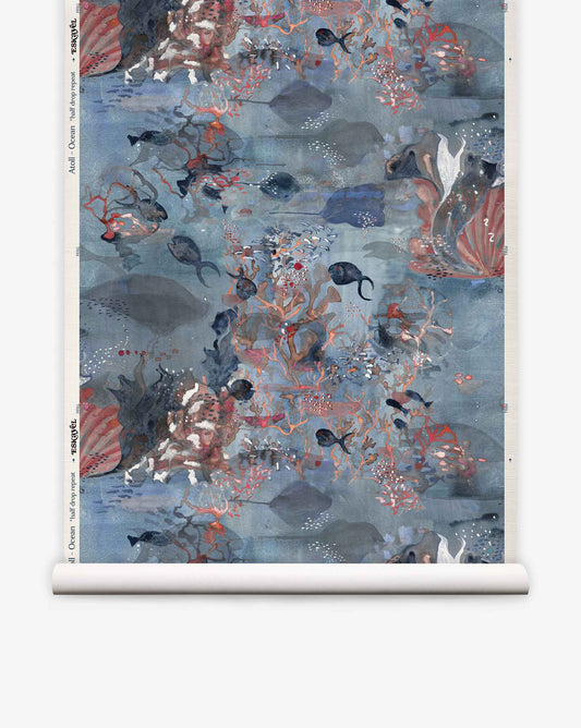 Introducing Atoll Grasscloth||Ocean: a hand-painted grasscloth wallpaper roll showcasing a watercolor-inspired underwater scene filled with fish, coral, seaweed, and bubbles in elegant shades of blue, red, and gray.