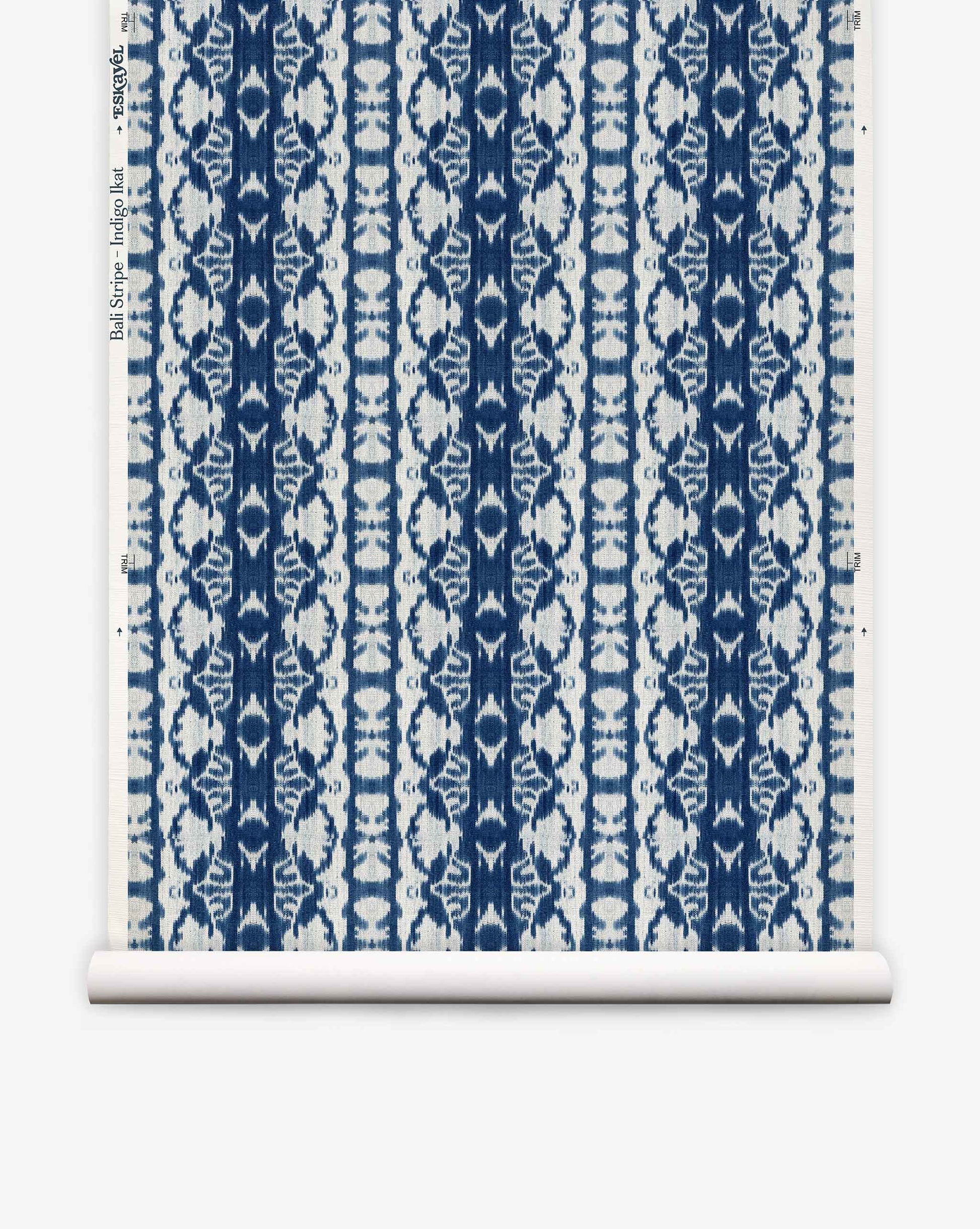 Bali Stripe Grasscloth||Indigo Ikat is a blue and white wallpaper roll featuring a repeating floral and geometric pattern in vertical stripes on a white background, inspired by indigo ikat for an abstract aesthetic.