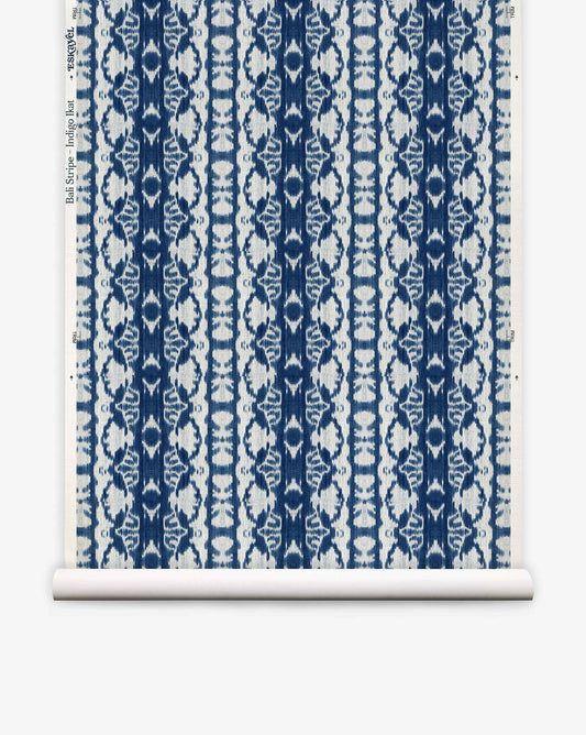 Bali Stripe Grasscloth||Indigo Ikat is a blue and white wallpaper roll featuring a repeating floral and geometric pattern in vertical stripes on a white background, inspired by indigo ikat for an abstract aesthetic.