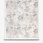 A roll of Bosky Toile Grasscloth in Chloros, featuring an abstract, dark green ink-wash design of layered branches and foliage on a textured cream background.