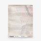 A rectangular Canopy Grasscloth Sample in Cameo, featuring textured grasscloth with a soft, abstract watercolor pattern in pink, grey, and green, with a product label at the bottom.