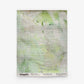 A square towel from the Cortile Grasscloth||Luminosa collection, featuring a light green and white watercolor pattern with horizontal textured lines and text along the bottom edge.