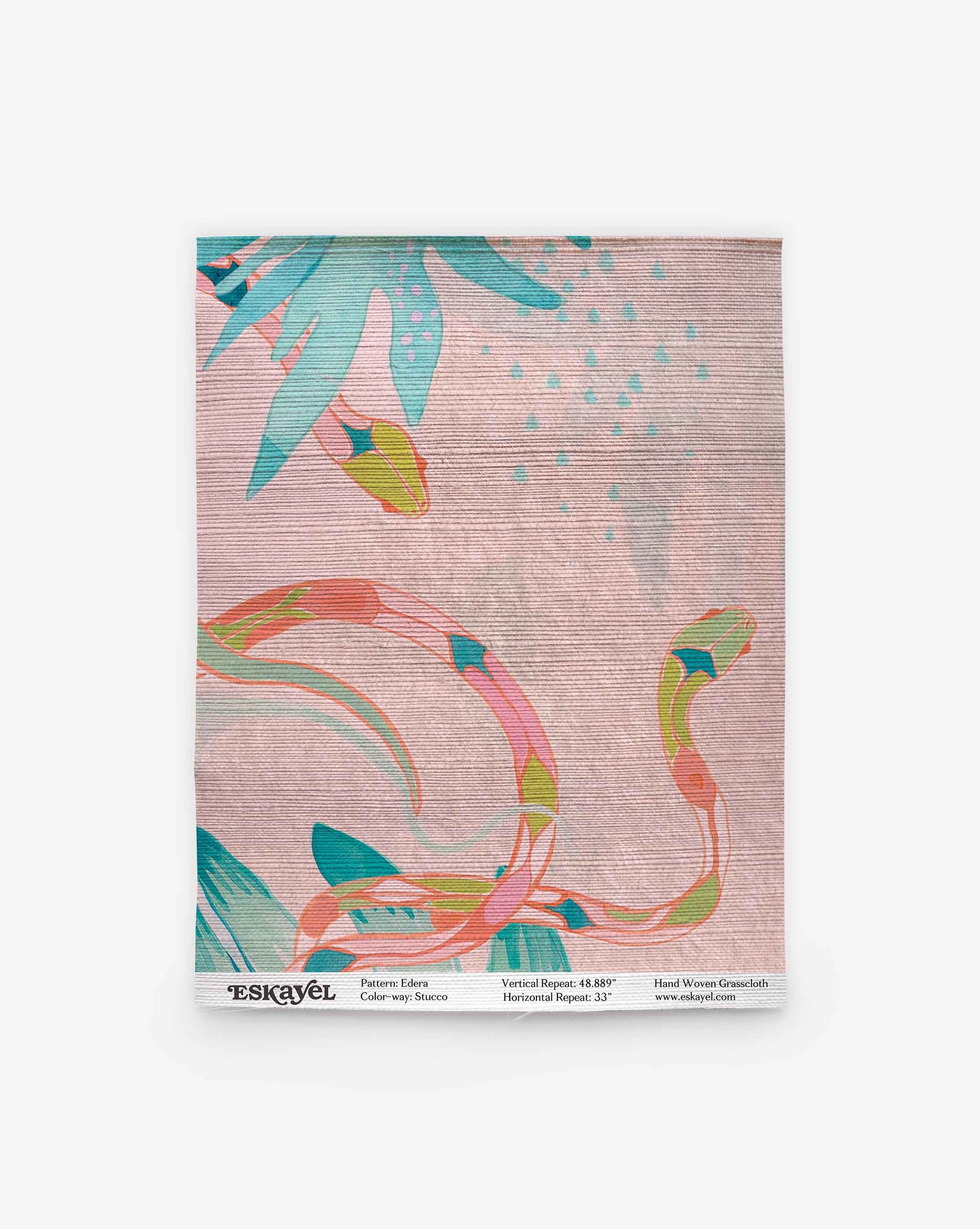 Sample of Edera Grasscloth wallpaper in the Stucco colorway, featuring abstract, colorful plant and snake-like patterns on a textured, light pink background. The sample includes product details at the bottom—perfect for reviewing before ordering for your space.