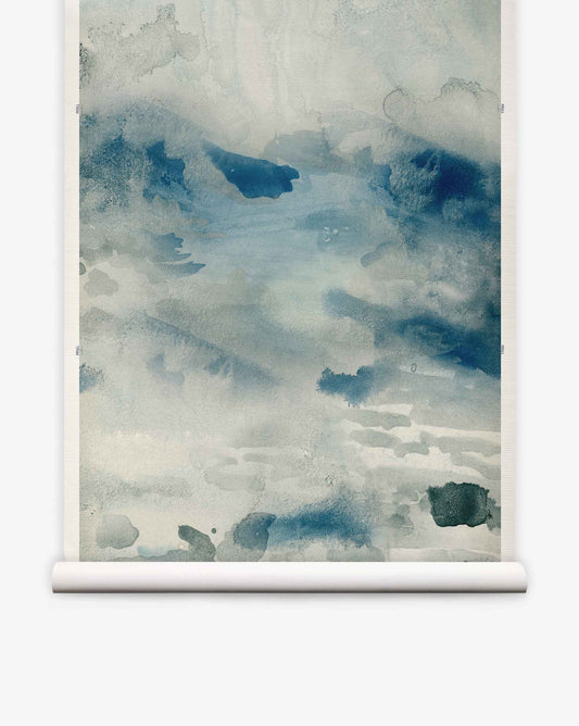 The Empyrean Grasscloth Mural||Cyrrus features abstract watercolor artistry in blue and gray tones, evoking a misty landscape or tranquil water scene—beautifully presented on a white scroll frame. This luxury mural is perfect for creating striking, sophisticated interiors, whether used as an elegant wallcovering or dramatic watercolor wallpaper.