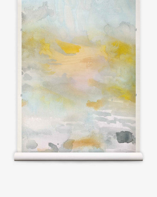 Empyrean Grasscloth Mural Dawn features soft yellow, gray, and blue shades blended in an abstract watercolor style, mounted on a white scroll hanger against a plain background—this piece captures the refined allure of a luxury mural and presents an elegant alternative to traditional watercolor wall coverings.