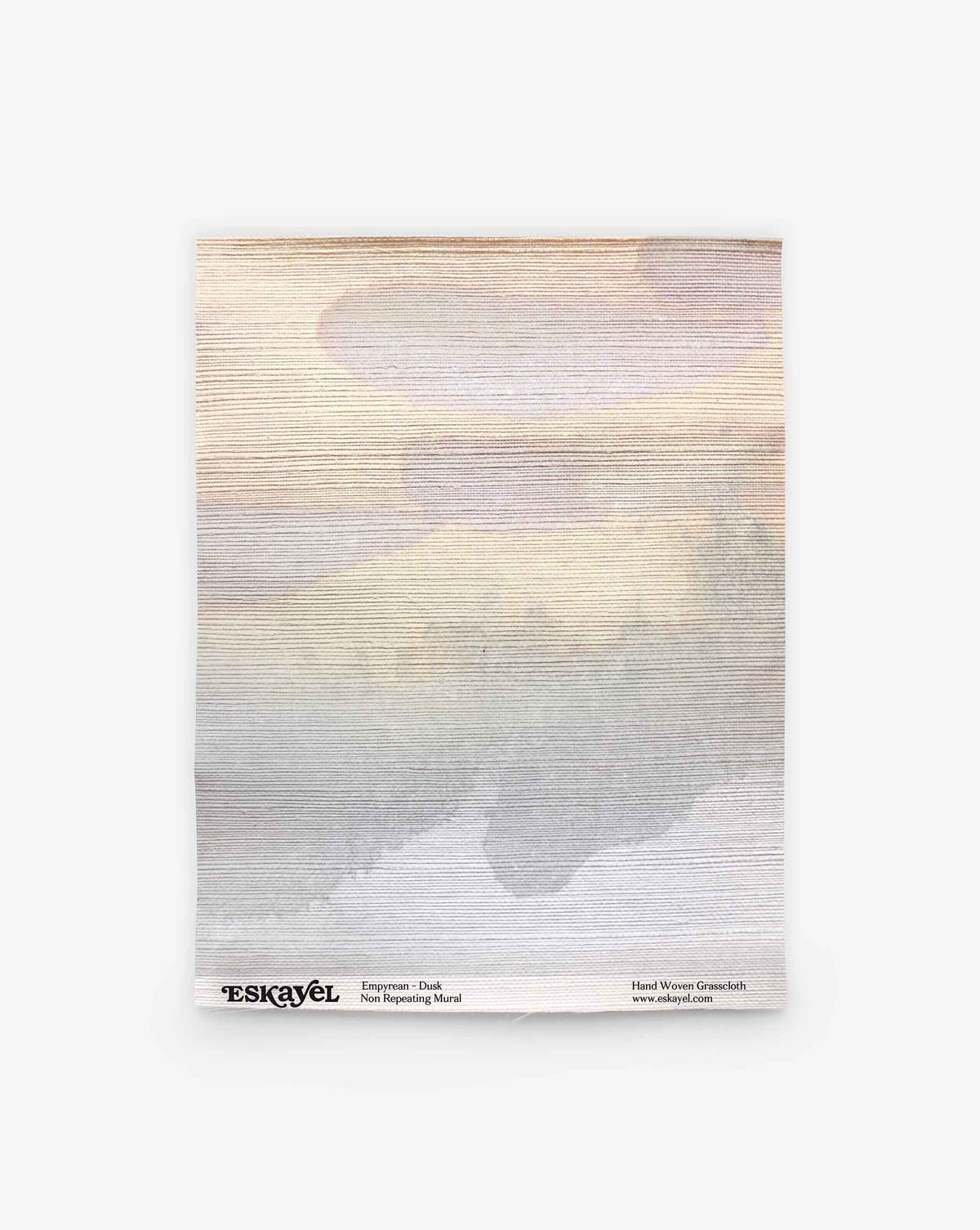 Experience the subtle elegance of the Empyrean Grasscloth Sample in Dusk—a square fabric featuring a muted watercolor-style pattern in beige, gray, and pale lavender tones. Branding and care details are printed along the bottom edge in small black text. Order your sample to appreciate this refined design firsthand.
