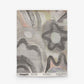 Square textile featuring abstract black, gray, and white patterns with arches and star motifs, reminiscent of Florianopolis-inspired design. “Floripa Grasscloth||Dusk” branding and product details are printed along the bottom edge.