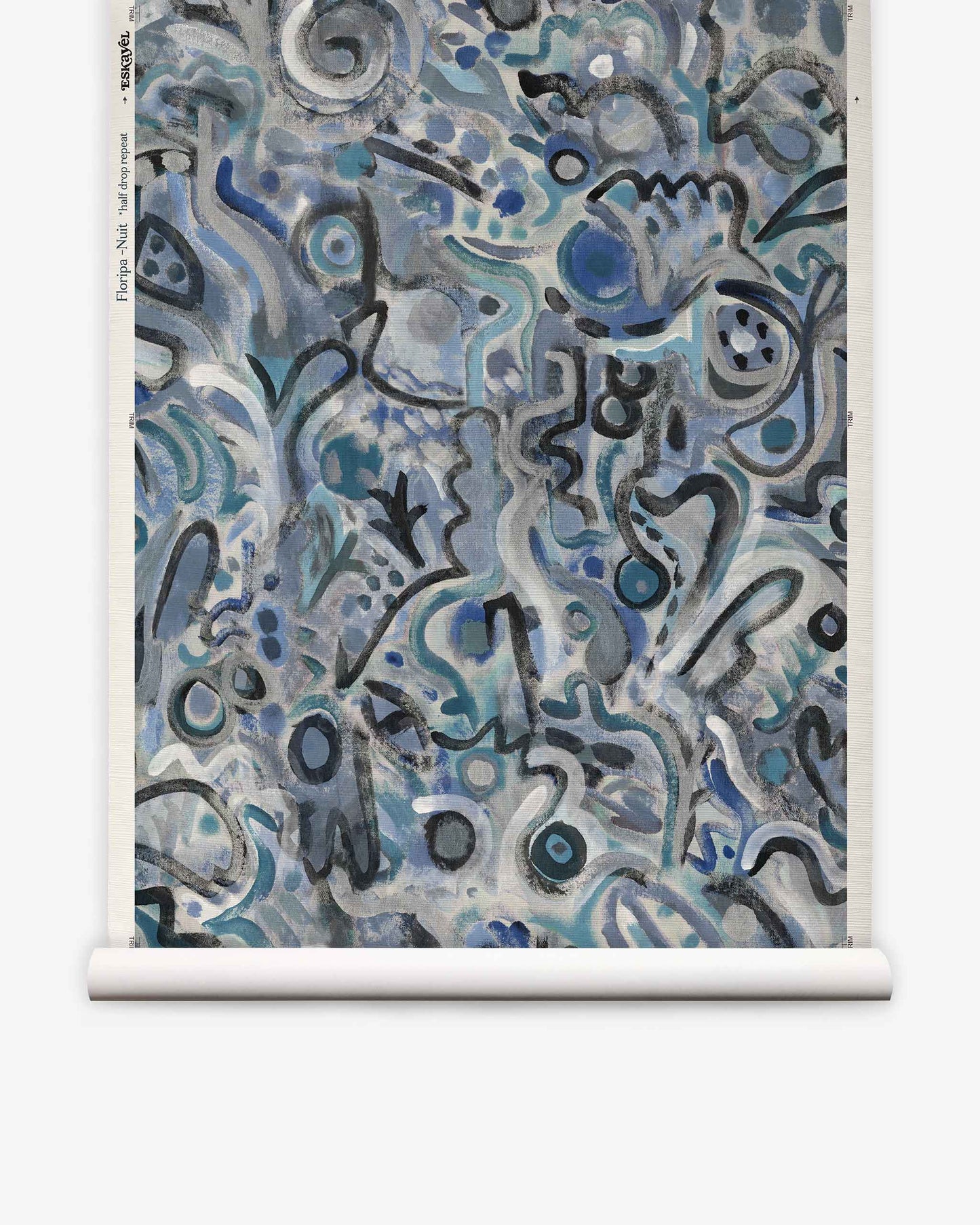 Floripa Grasscloth||Nuit features abstract artwork with swirling blue, gray, and black shapes and lines on a rolled canvas. The chaotic, organic patterns evoke doodles or graffiti, capturing the vibrant spirit of artist collaboration inspired by the dynamic culture of Florianopolis, Brazil.