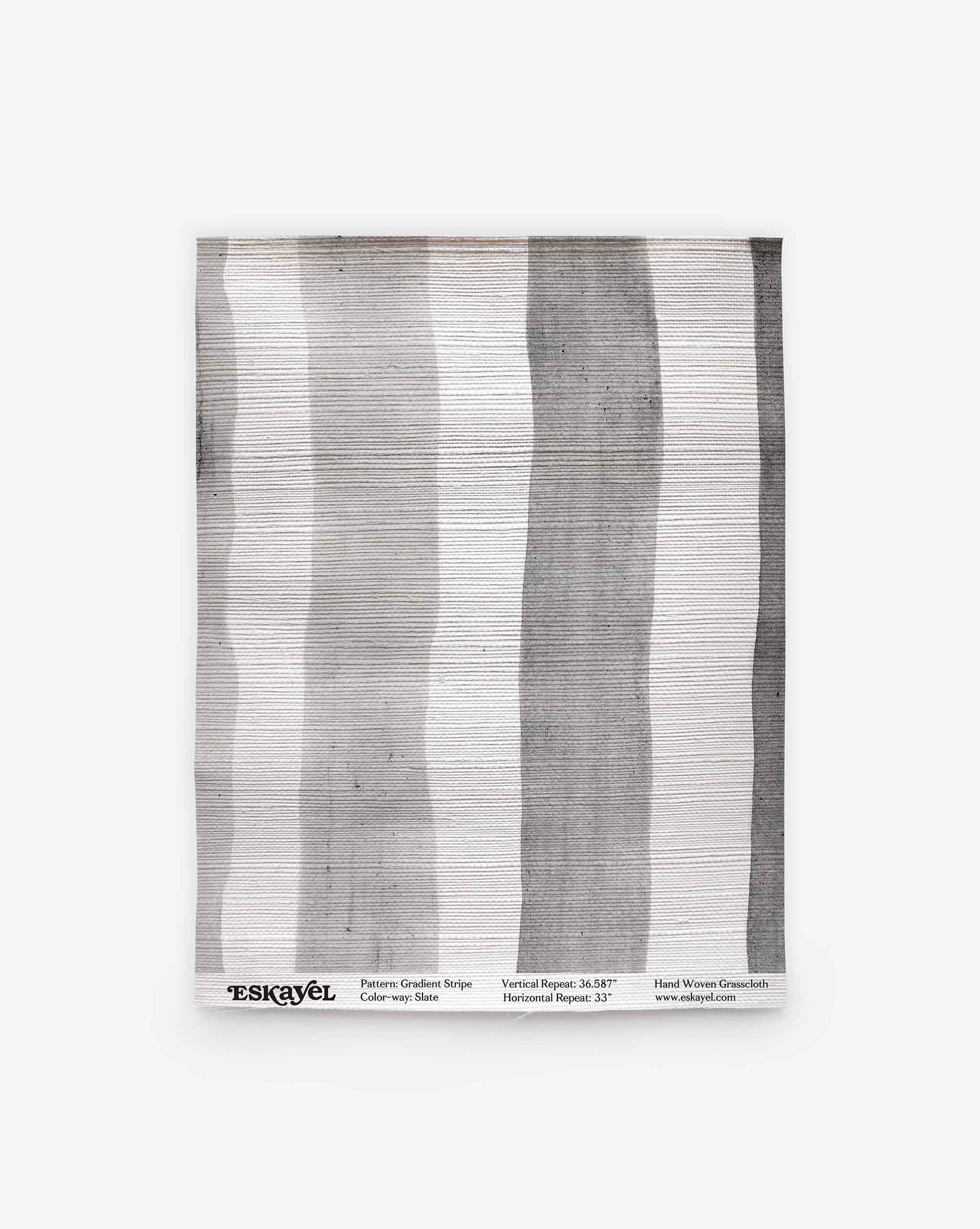 A handwoven textile featuring vertical grey and white stripes, the “Gradient Stripe Grasscloth Sample” in Slate is displayed flat against a white background. Order a sample to experience the quality and detail of this unique design firsthand.