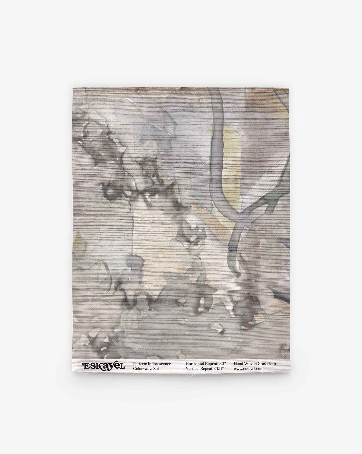 A square swatch of handwoven fabric with a gray and beige abstract watercolor pattern, labeled “Inflorescence Grasscloth||Sol” with product details at the bottom.