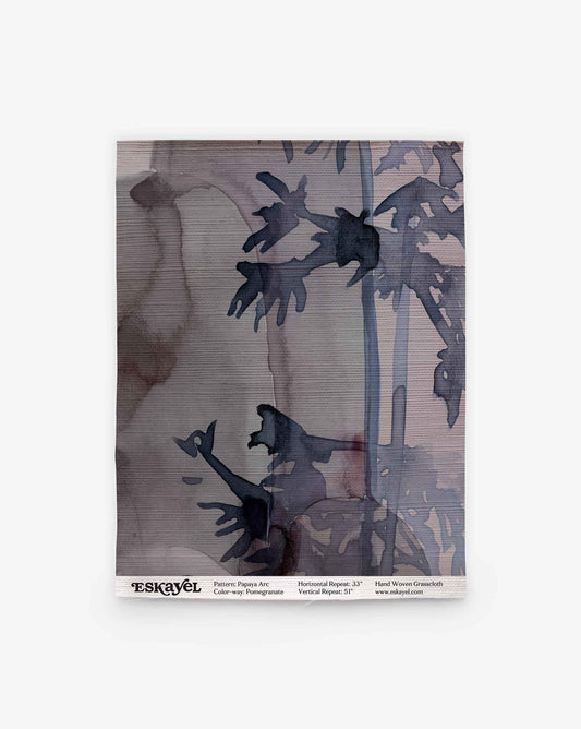 Rectangular Papaya Arc Grasscloth Sample in Pomegranate, featuring a dark, abstract botanical print on a textured, mauve-toned background.
