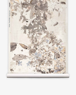 A roll of Pétalos Grasscloth||Sand Dollar wallpaper featuring a neutral-toned ink-wash pattern with leaves, flowers, and small animals on a light background.