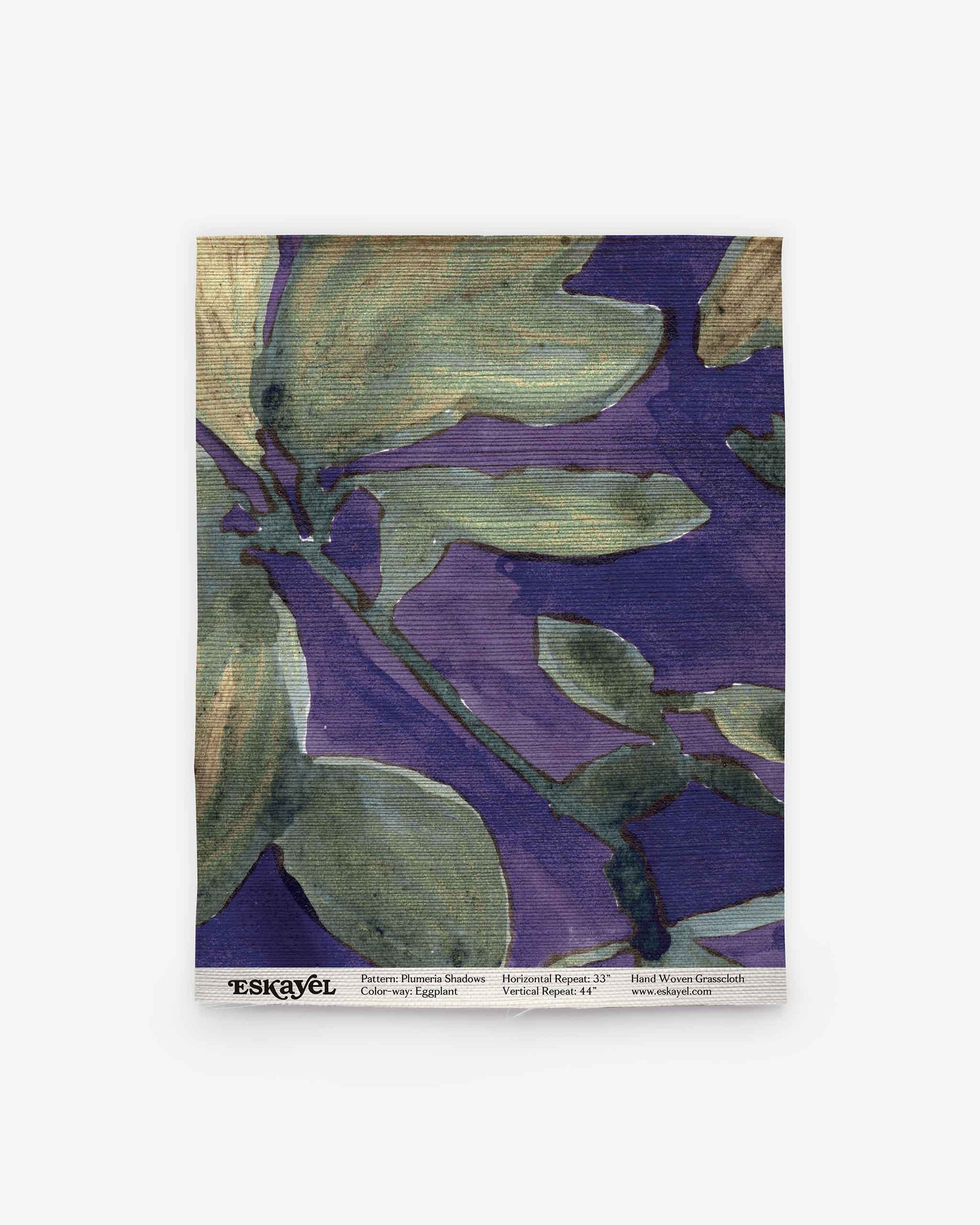 Square swatch of fabric featuring the Plumeria Shadows Grasscloth pattern in Eggplant, with abstract floral designs in green and purple hues. The bottom edge is marked with “ESKAYEL” and includes pattern and dimension details. Perfect for exploring your next project—Order a sample to experience the unique texture and vibrant colors firsthand.