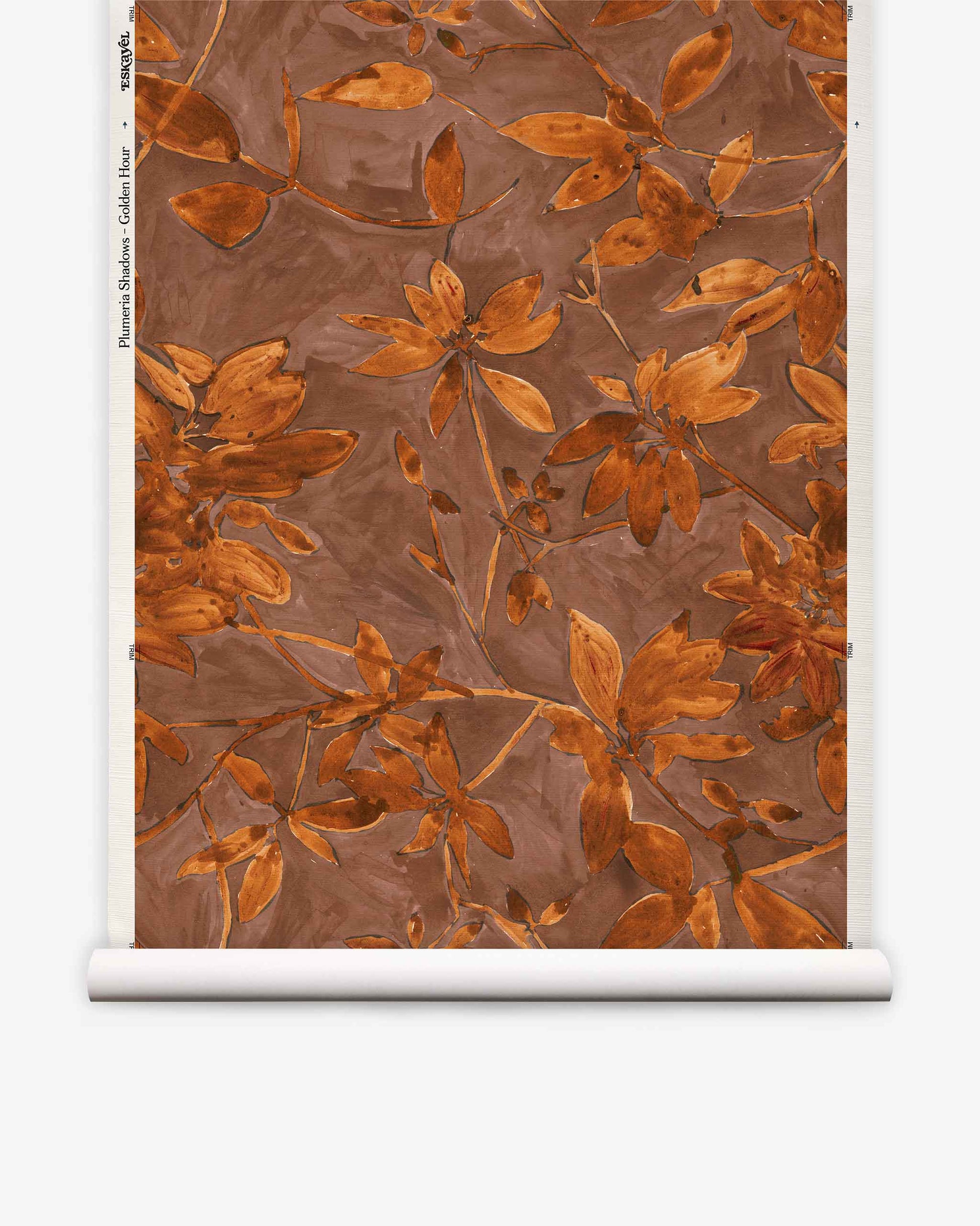 Plumeria Shadows Grasscloth||Golden Hour is a wallpaper roll with a brown background adorned with orange-brown leaves and branches in a watercolor style. Part of the Plumeria Shadows wallpaper collection, this design evokes the warm, tropical ambiance of Costa Rica’s golden hour in any space.