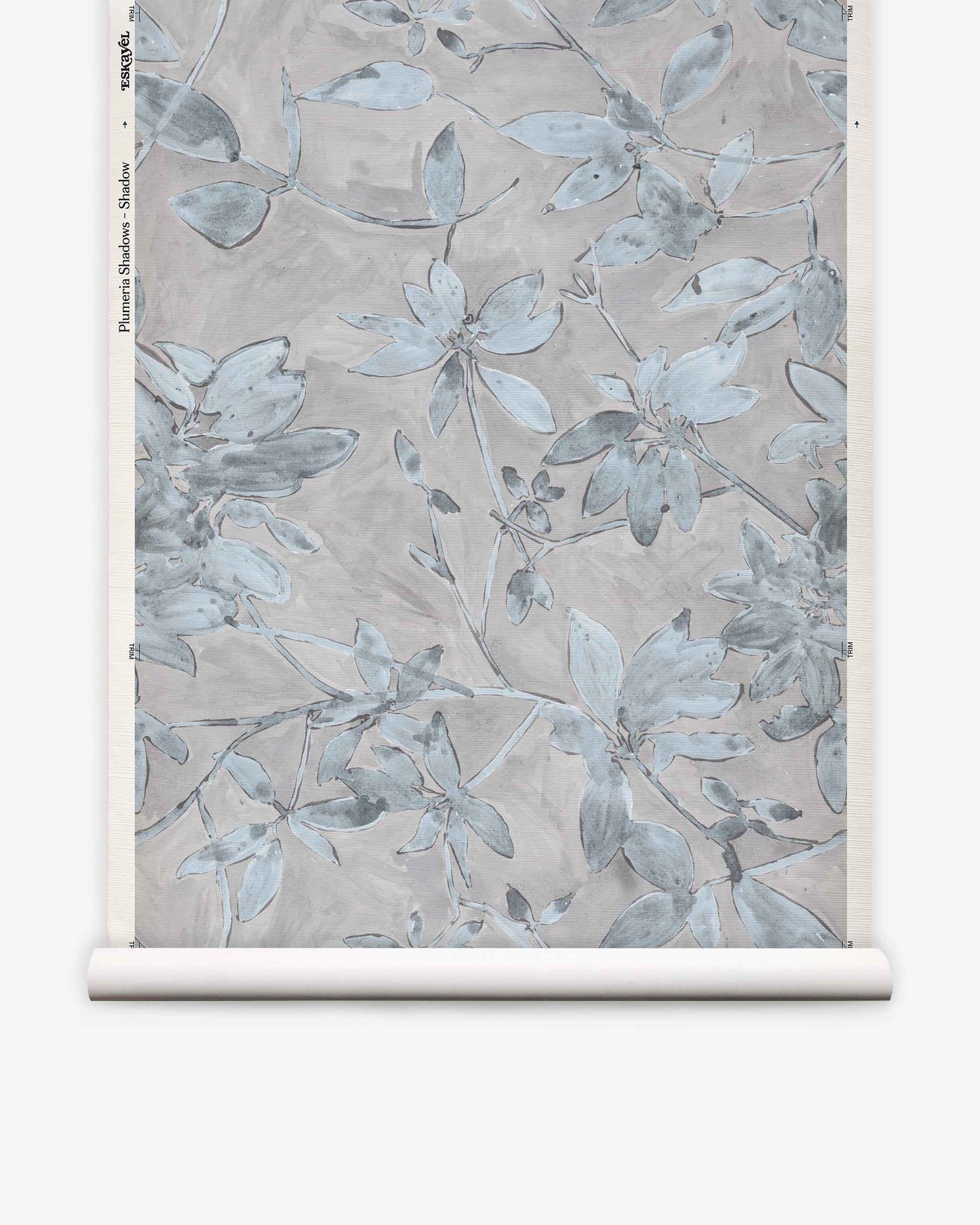 A rolled sheet of Plumeria Shadows Grasscloth||Shadow wallpaper featuring a muted blue and gray floral pattern on a light background, perfect for those seeking a subtle yet elegant tropical wallpaper look.