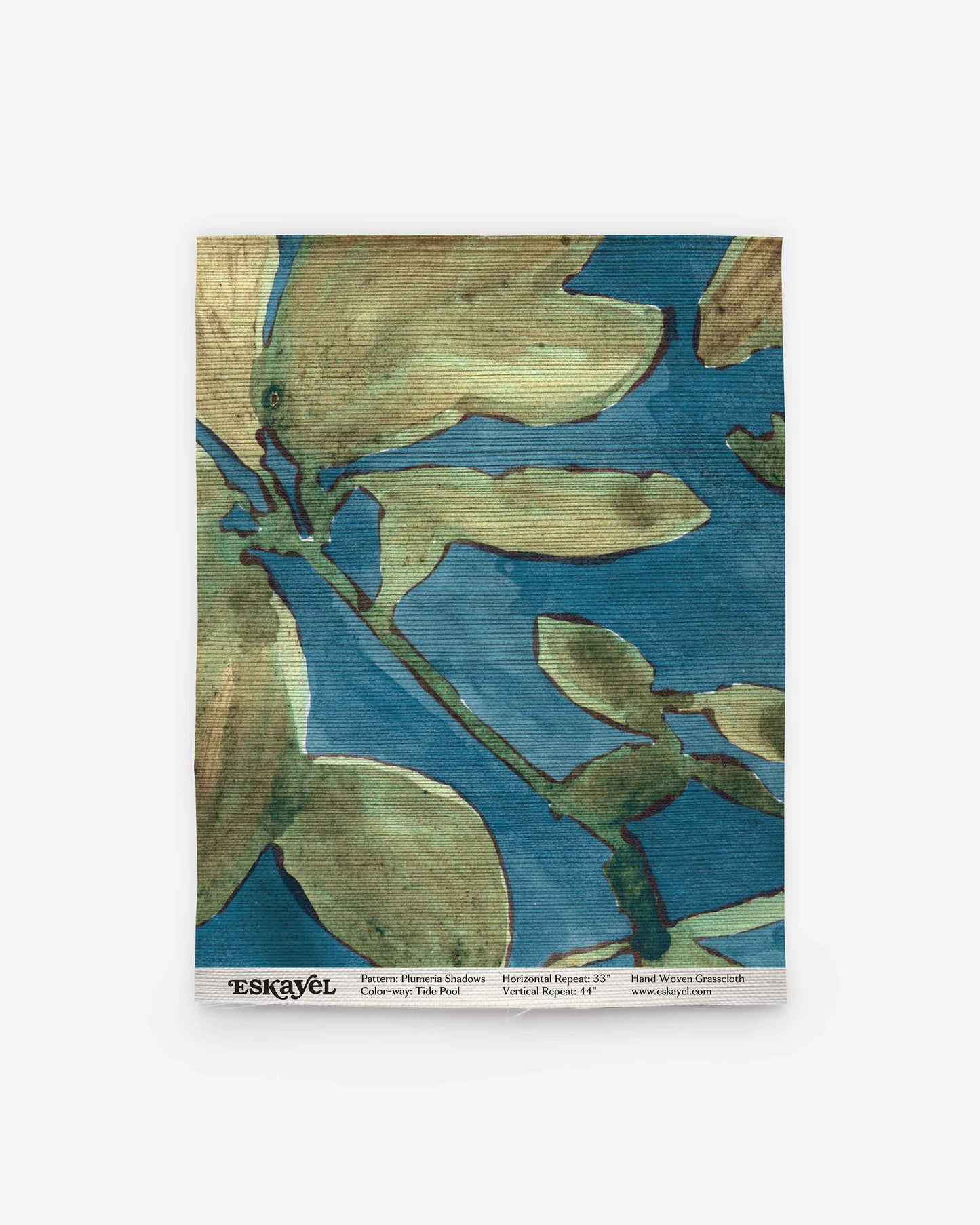 Square cloth featuring an abstract floral design in blue and green tones, reminiscent of the Plumeria Shadows Grasscloth||Tide Pool pattern. Text including “ESKAYEL” and product details is printed along the bottom edge.