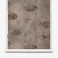Shoal Grasscloth||Amber wallpaper features illustrated stingrays and small fish swimming in muted, amber-toned hues, displayed on a sample roll. The design incorporates subtle watercolor brushstrokes that evoke the delicate textures of silk wallcovering.