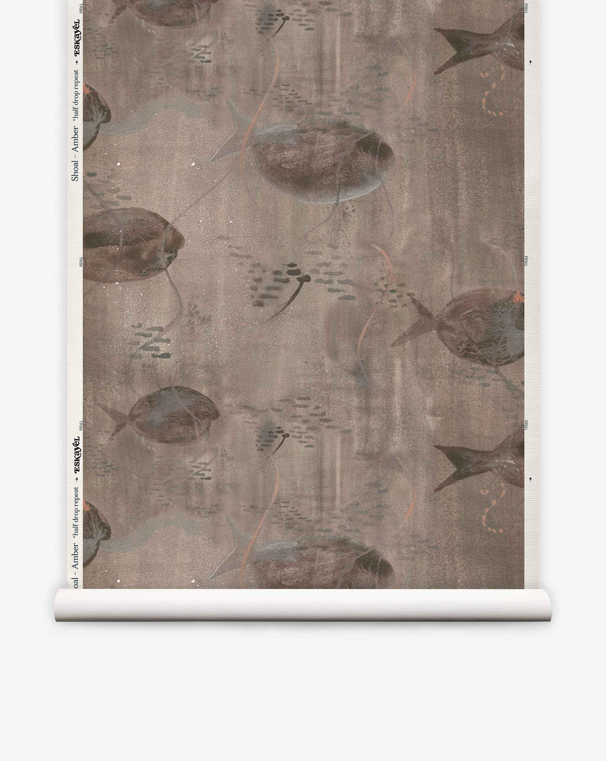 Shoal Grasscloth||Amber wallpaper features illustrated stingrays and small fish swimming in muted, amber-toned hues, displayed on a sample roll. The design incorporates subtle watercolor brushstrokes that evoke the delicate textures of silk wallcovering.