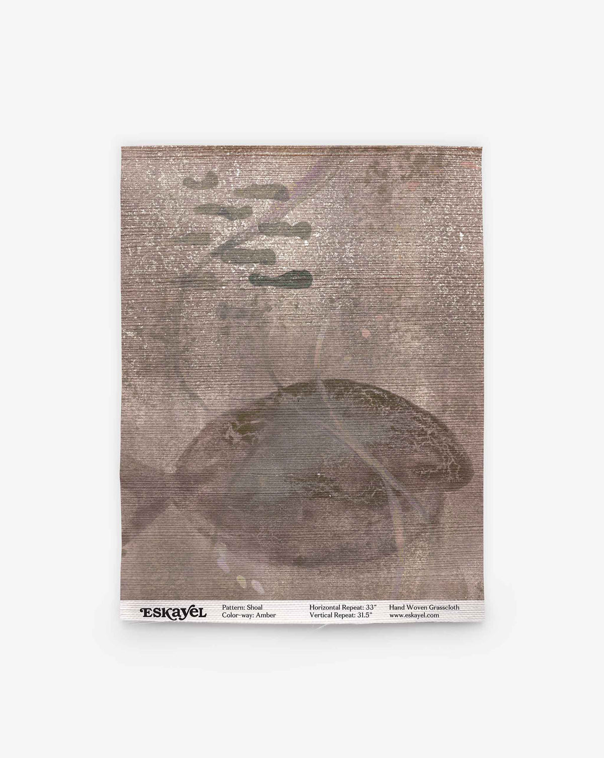 A square sample of Shoal Grasscloth in Amber, featuring a subtle abstract pattern in muted brown tones with faint overlapping shapes and a gently textured surface. Measurements and text are printed along the bottom edge. Ideal for design planning—order this sample to experience the quality firsthand.