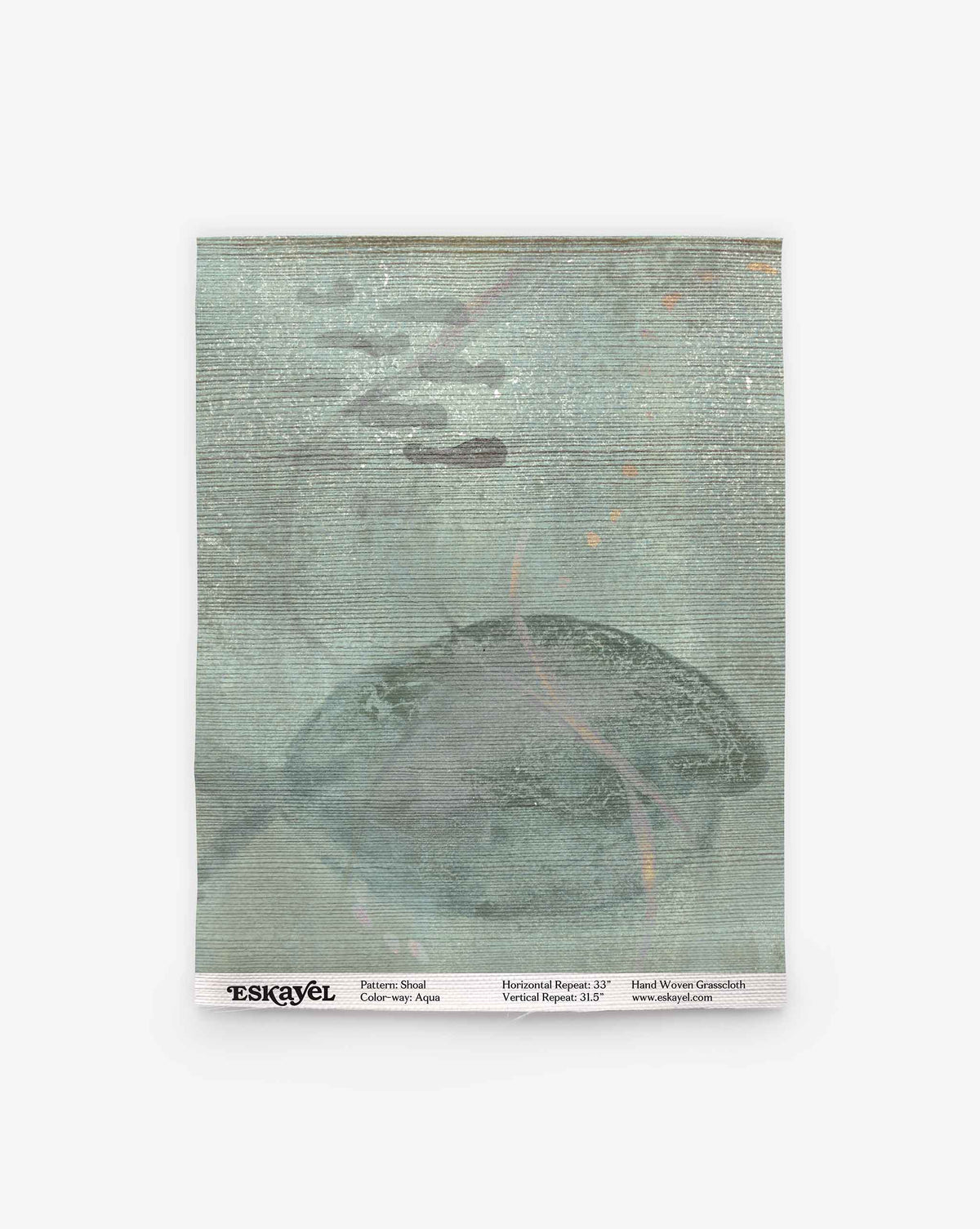 Square fabric swatch in muted aqua displays an abstract, textured design with a prominent oval shape and delicate curved lines; the text at the bottom reads “ESKAYEL” along with the Shoal Grasscloth Sample||Aqua pattern, color, and size details. Order a sample to experience its unique texture and refined color palette firsthand.