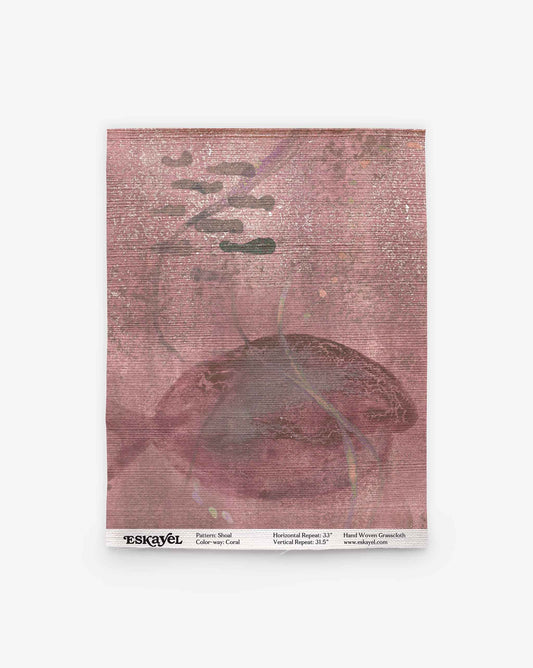 A pink textured square featuring abstract cloud shapes and a subtle fish motif; the label at the bottom reads “ESKAYEL” along with pattern details. Order a Shoal Grasscloth Sample in Coral to experience this unique design firsthand.