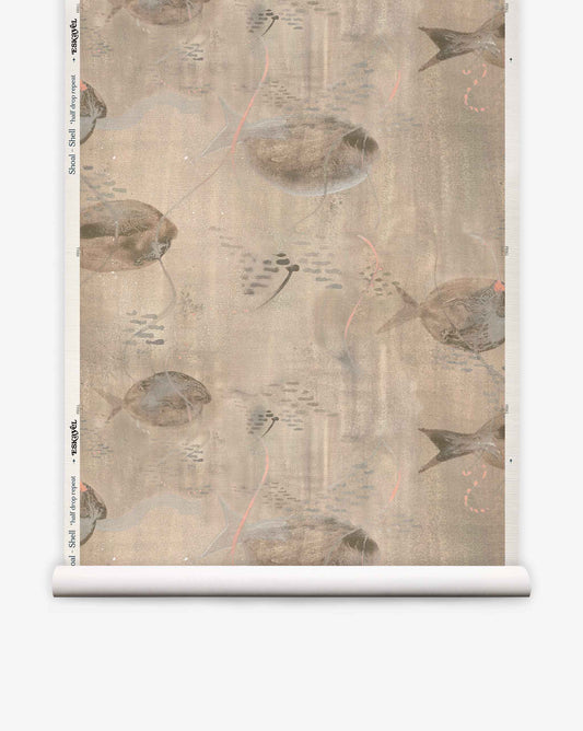 A roll of Shoal Grasscloth||Shell wallpaper featuring a muted, abstract pattern of stingrays and fish swimming on a beige background, reminiscent of delicate watercolor art.